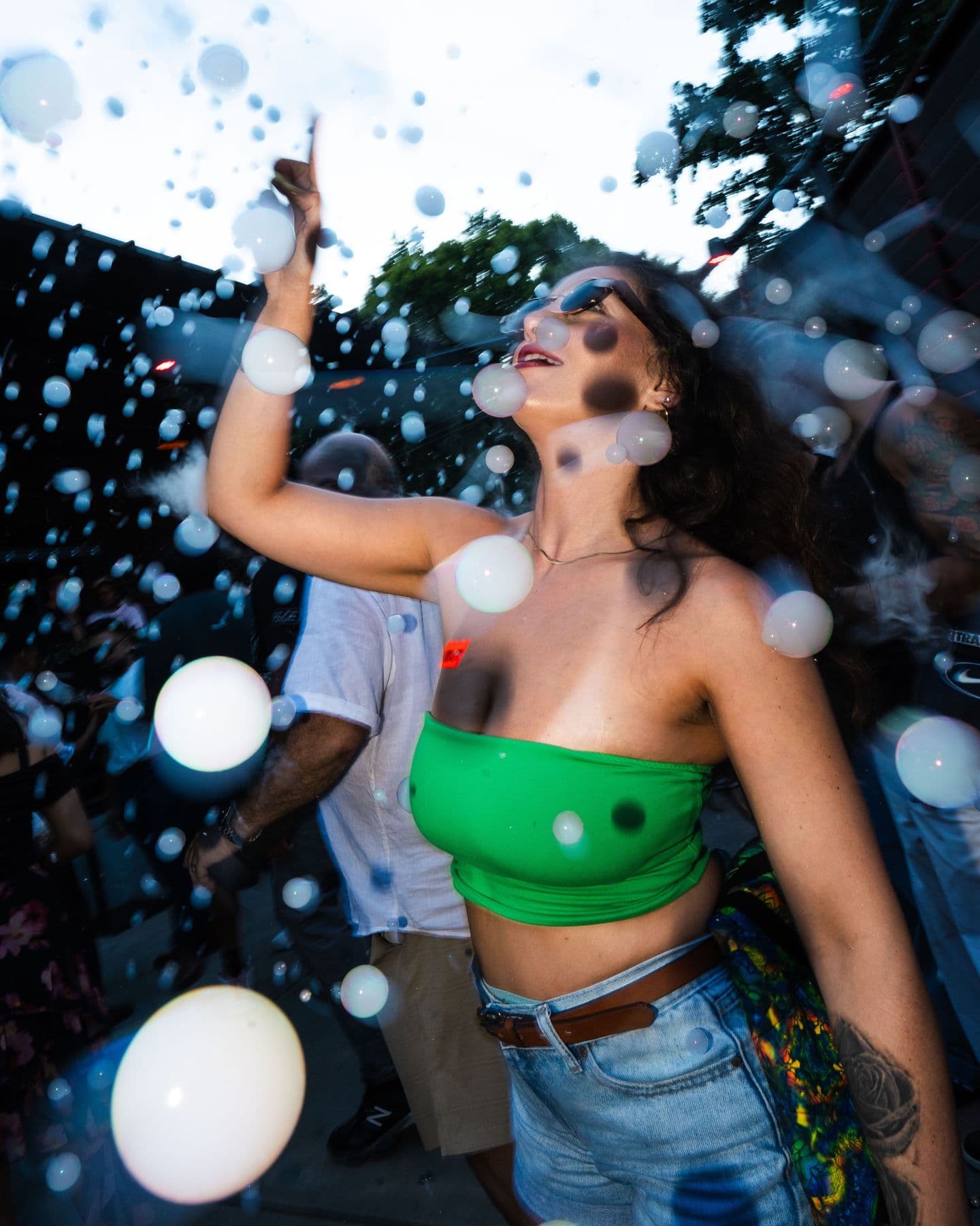 A dancer in a green top surrounded by bubbles
