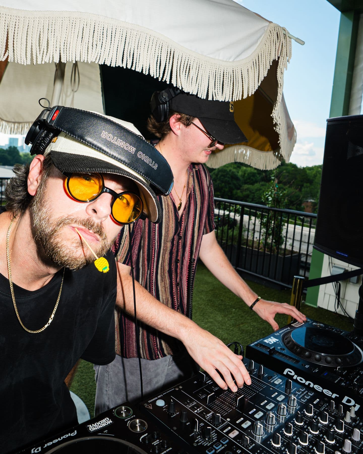 Jobayashi in yellow sunglasses at the decks, Axial behind him