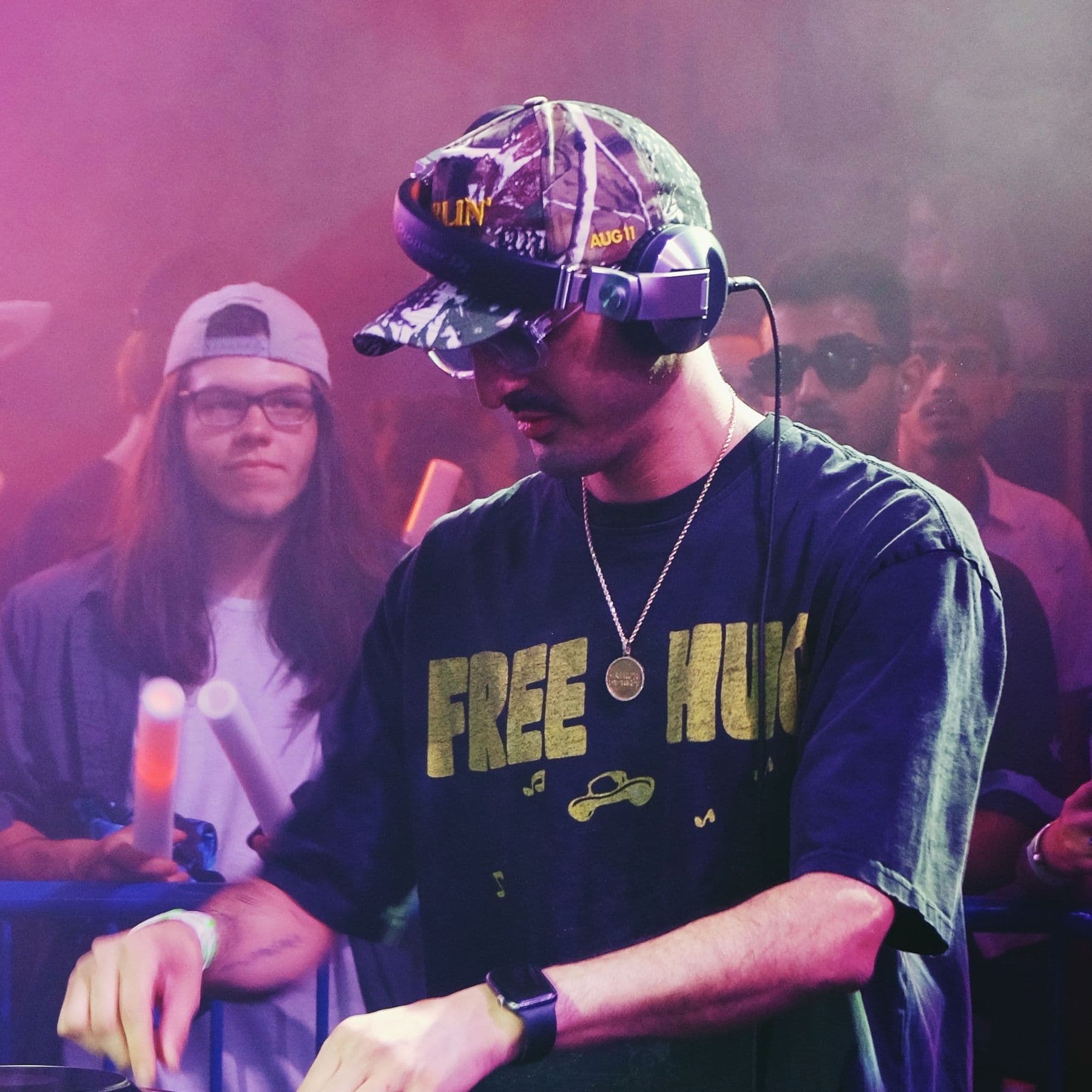 NadUka at the Pioneer decks in a camo cap and headphones
